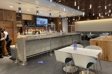 a bar with white tables and chairs