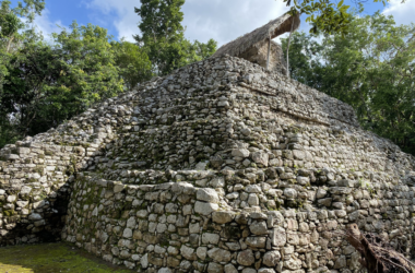 a stone structure with a thatched roof