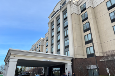 a group of people outside of a hotel