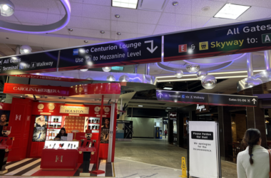 a large airport terminal with signs and a sign