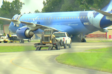 a plane with a tractor on the ground