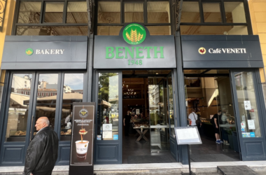 a store front with people walking in the background