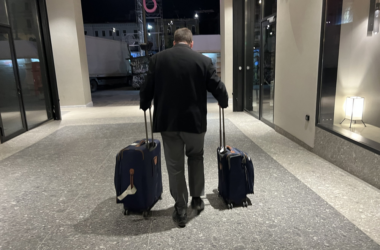 a man pulling luggage in a hallway