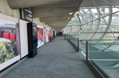 a walkway with a glass wall and a large window