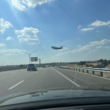 a plane flying over a road