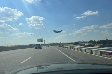 a plane flying over a road