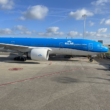 a blue and white airplane on a tarmac