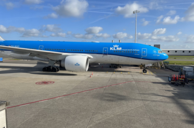 a blue and white airplane on a tarmac
