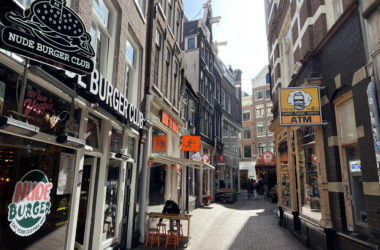 a street with buildings and people walking down it