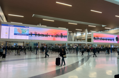 people walking in a large airport terminal