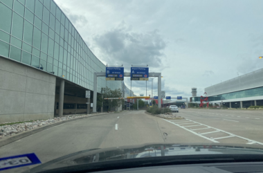 a view from a car of a road with a sign on it