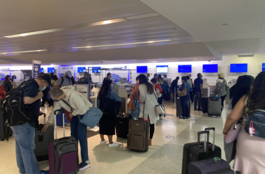 a group of people with luggage in a terminal