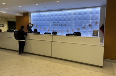 a group of people standing at a reception desk