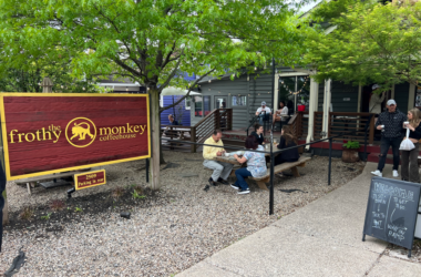 a group of people sitting on benches outside a building