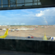 a view of airplanes at an airport from a window