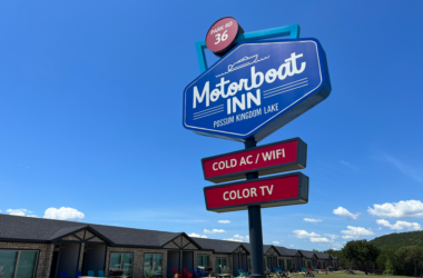 a sign with a group of buildings in the background