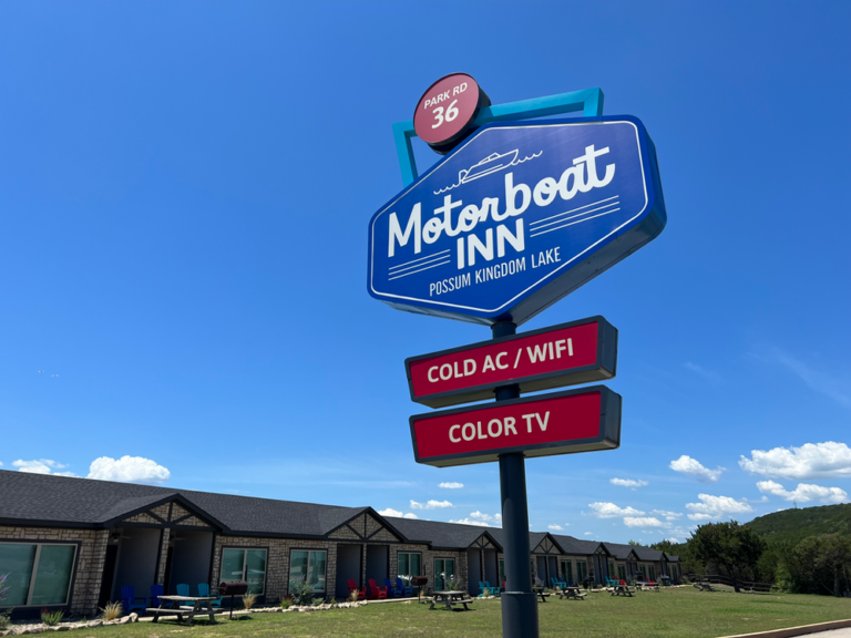 a sign with a group of buildings in the background
