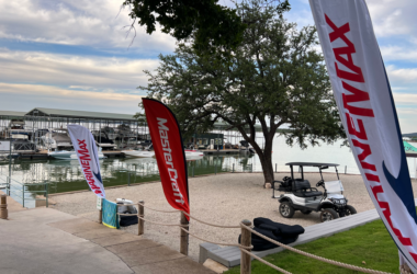 a group of flags next to a body of water