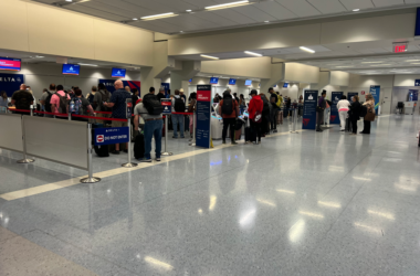 a group of people standing in a line at an airport