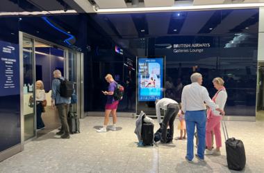 a group of people standing in front of a glass building