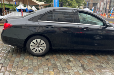 a black car parked on a brick road