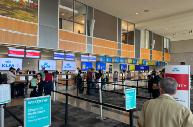 people in an airport with people standing in line