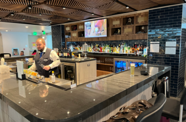 a man behind a counter in a bar