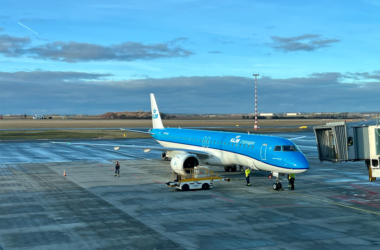 a blue airplane on a runway