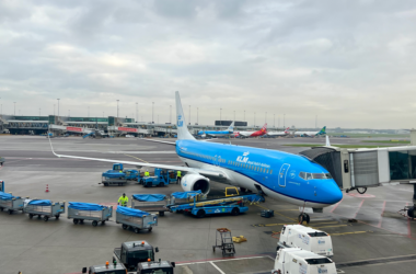 a blue airplane on a tarmac
