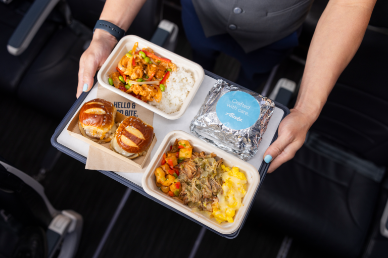 a person holding a tray of food