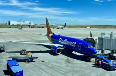 a blue airplane on a runway