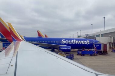 a blue airplane parked at an airport