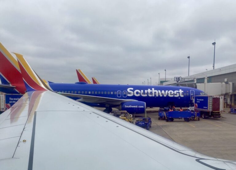 a blue airplane parked at an airport