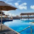 a pool with umbrellas and chairs