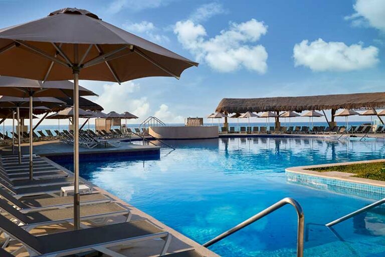 a pool with umbrellas and chairs