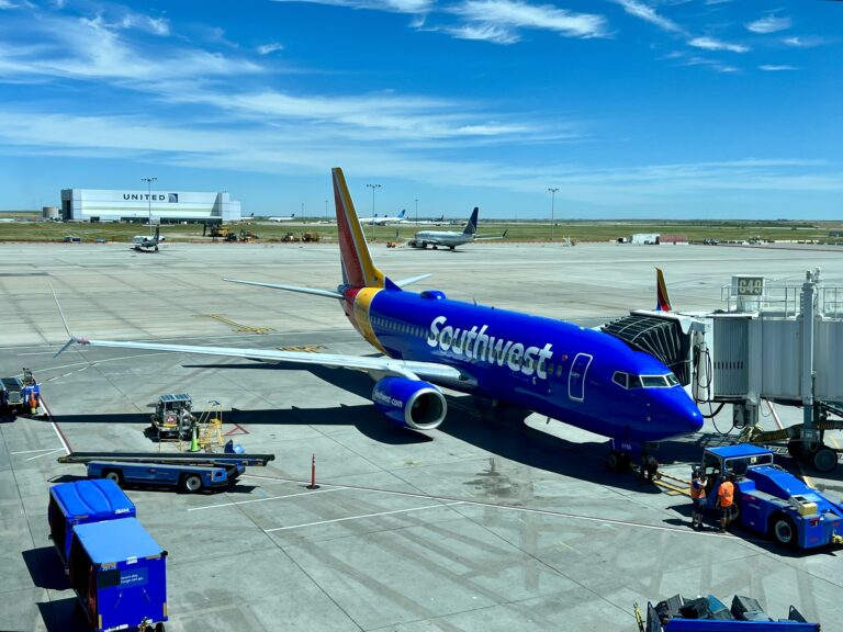 a blue airplane on a tarmac