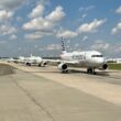 a group of airplanes on a runway