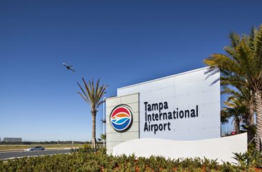 a sign with a plane flying in the sky