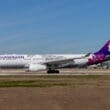 a white and purple airplane on a runway