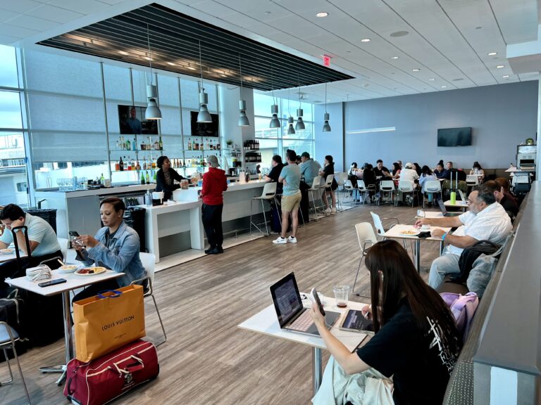 a group of people sitting at tables in a restaurant