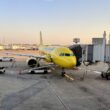 a yellow airplane at an airport