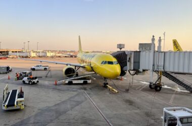 a yellow airplane at an airport