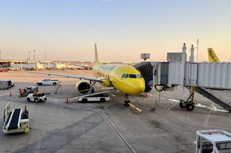 a yellow airplane at an airport