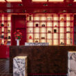 a counter in a room with red and white shelves