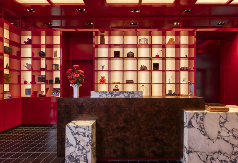 a counter in a room with red and white shelves