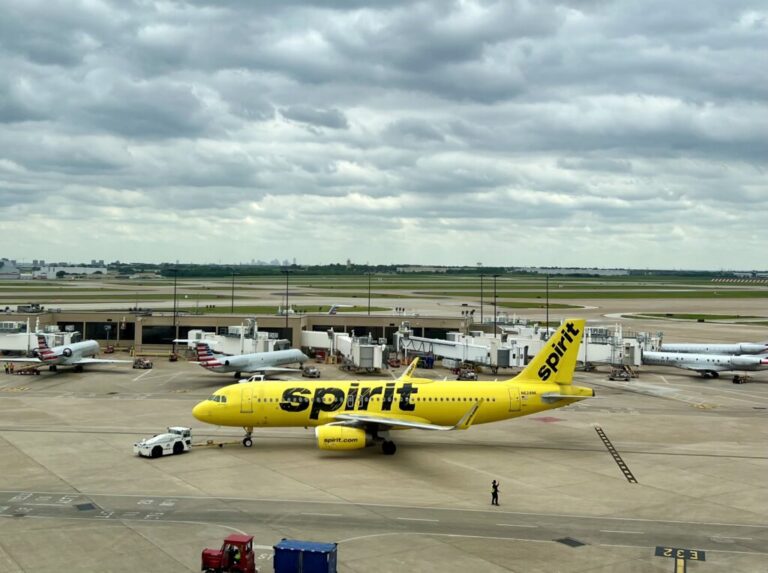 a yellow airplane on a runway