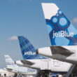 a group of airplanes parked in a row