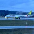 a white airplane on a runway