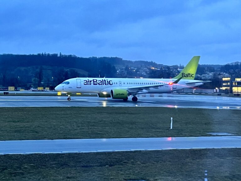 a white airplane on a runway