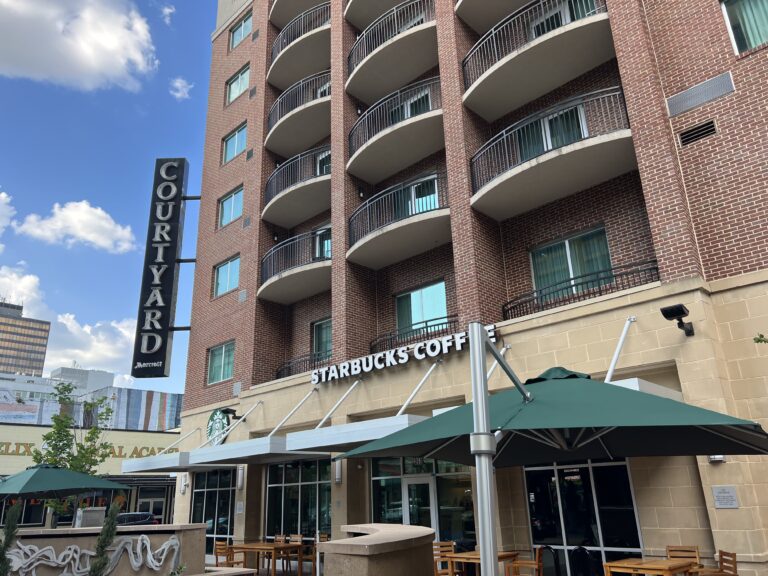 a building with many balconies and a sign